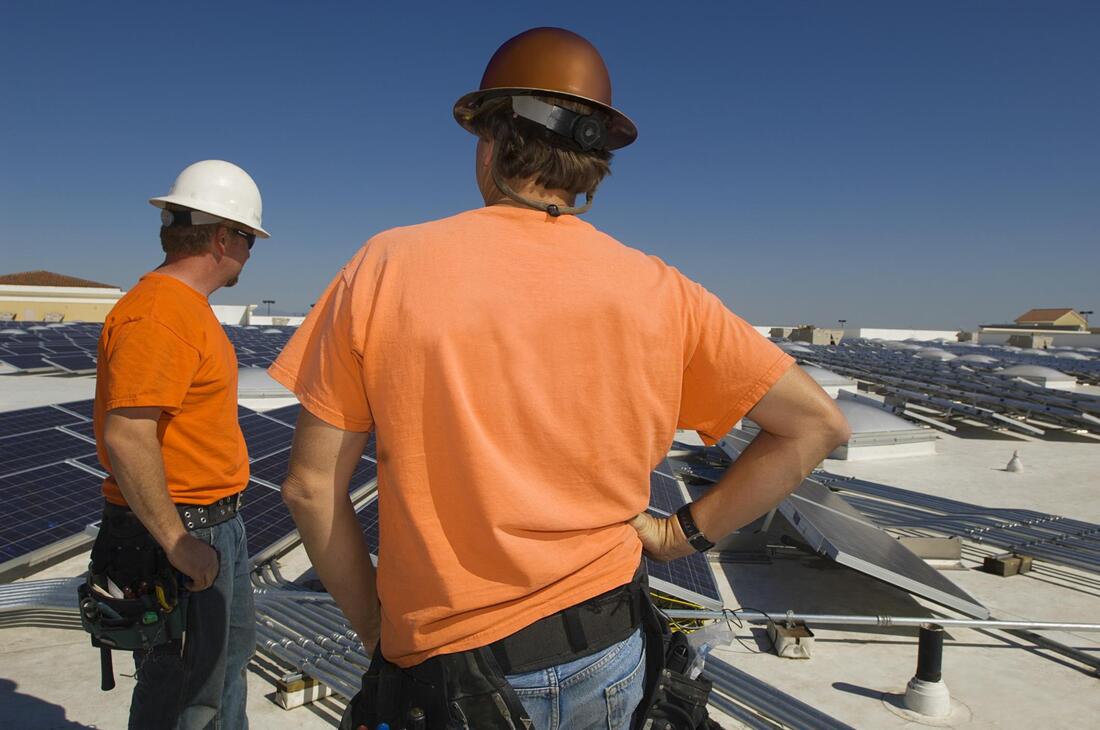 two workers standing in the roof